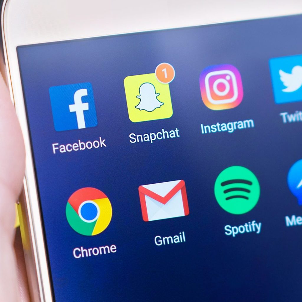 pexels photo 533446 533446 A person's hand holding a smartphone displaying social media and communication apps.