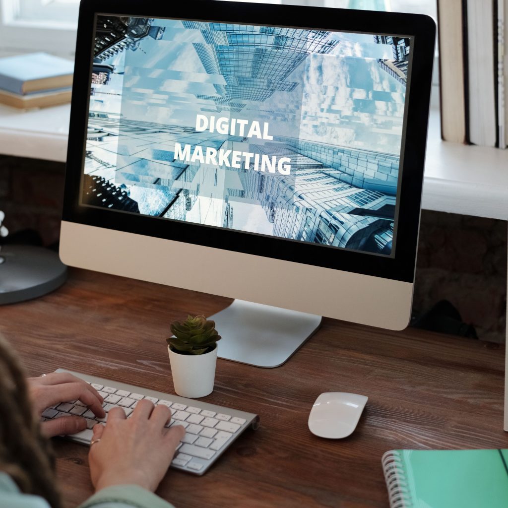 Close-up of a woman working on a digital marketing project in a home office setting.